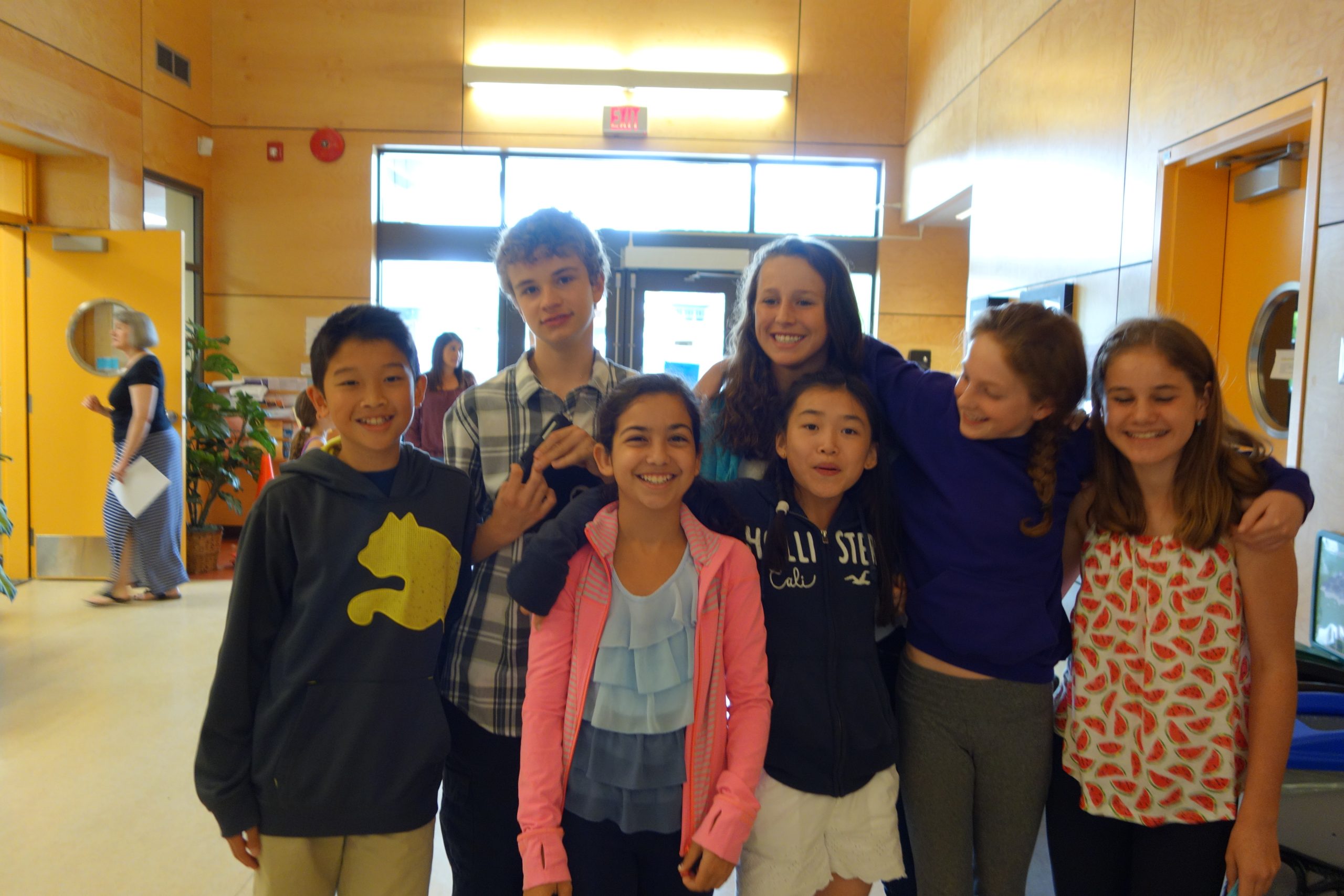 Photo of a school hallway decorated with key members of Club G, promoting community over ego.