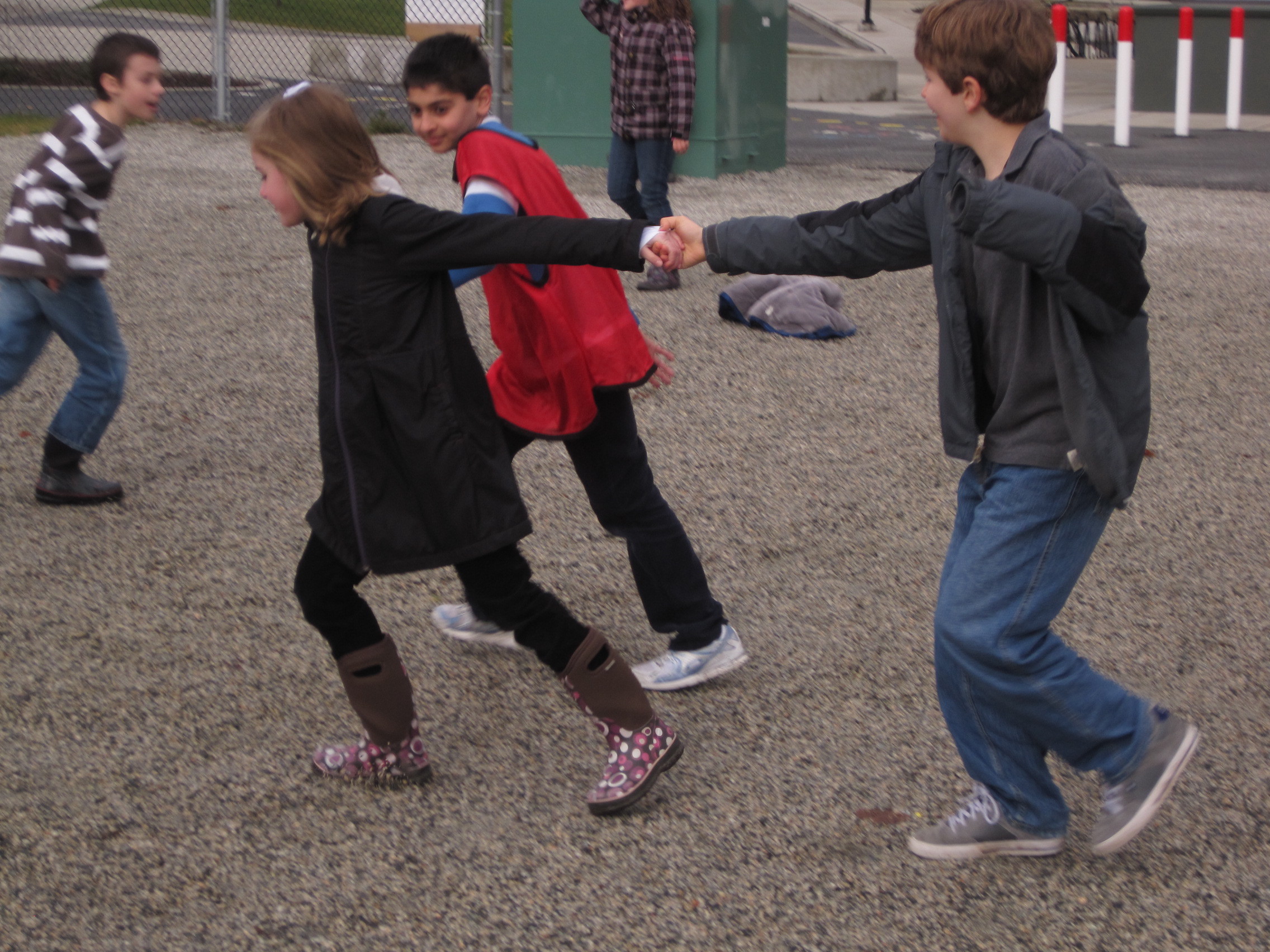 Kids playing together in a schoolyard, illustrating why community beats individual ego.