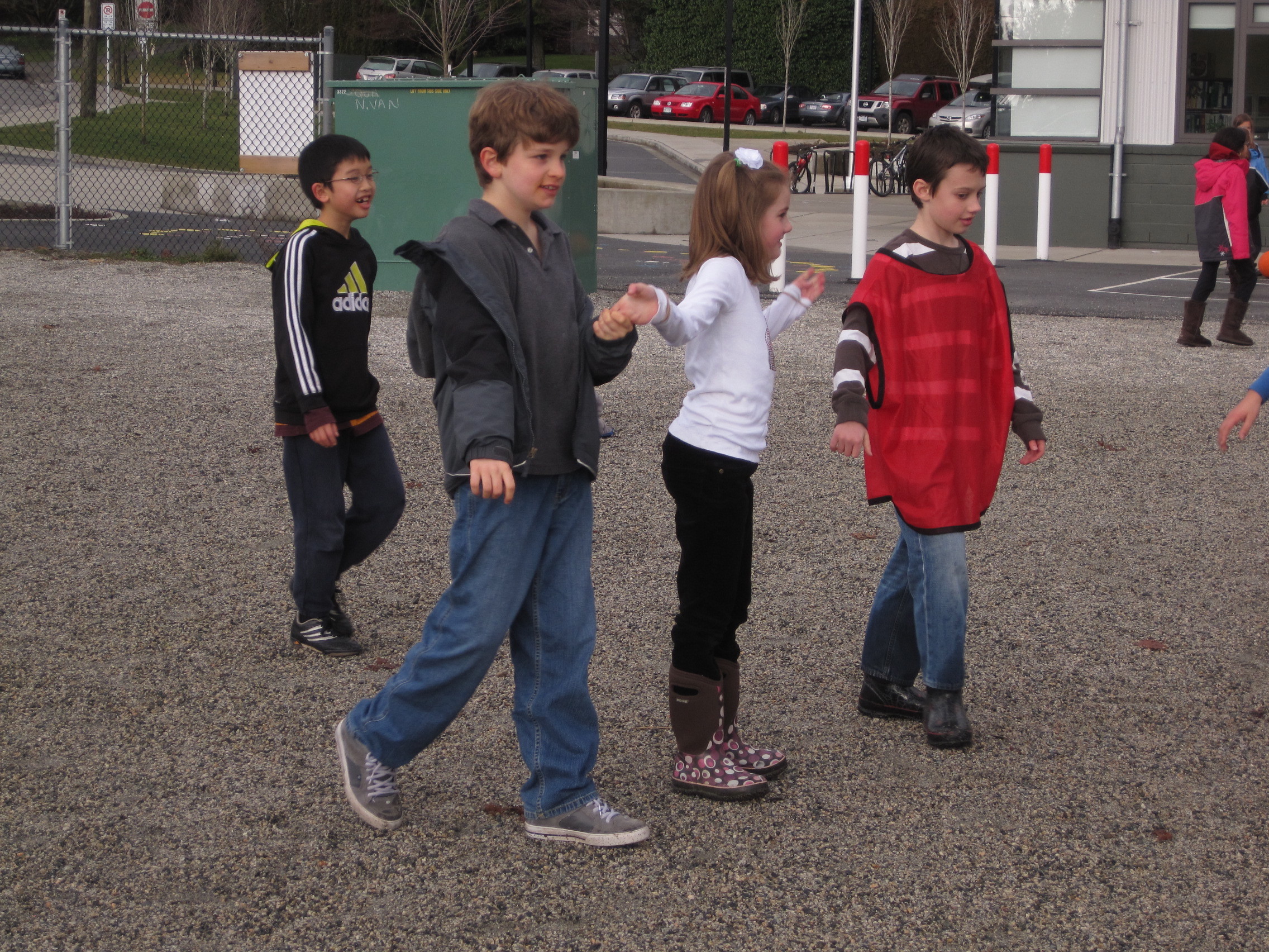 Kids playing chain tag together in a schoolyard, illustrating why community beats individual ego.
