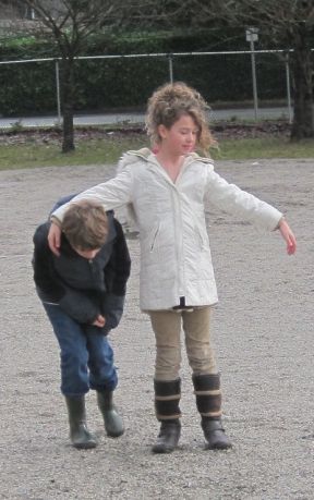 Kids playing freeze tag together in a schoolyard, illustrating why community beats individual ego.